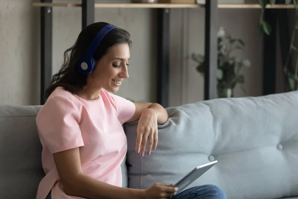 Happy ethnic woman in headphones talk on tablet — Stock Photo, Image