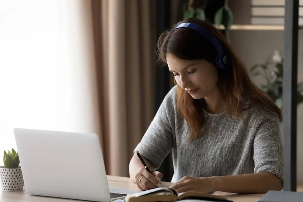 Estudiante milenaria en auriculares estudia en casa —  Fotos de Stock