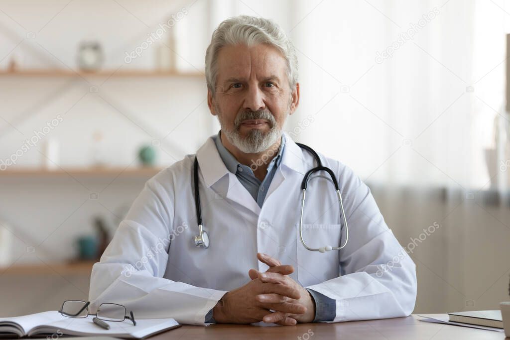 Portrait of pleasant professional older mature gp physician.