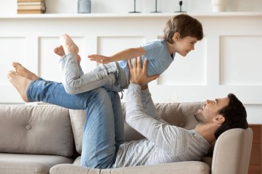 Mutlu baba evde küçük oğluyla oynuyor.