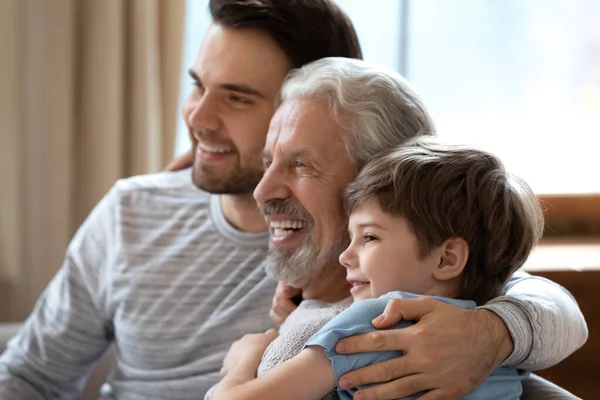 Happy three generations of men look in distance dreaming — Stock Photo, Image