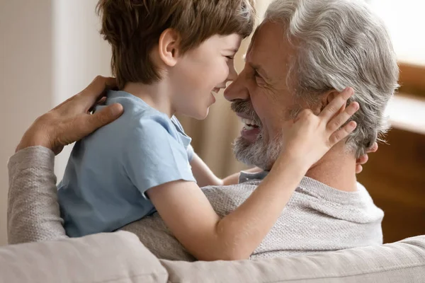 Happy small boy hug smiling mature grandfather — Stock Photo, Image