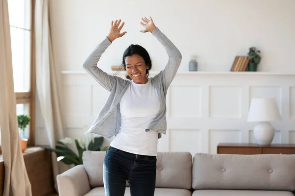 Happy laughing young african american woman dancing at home. — Stok Foto