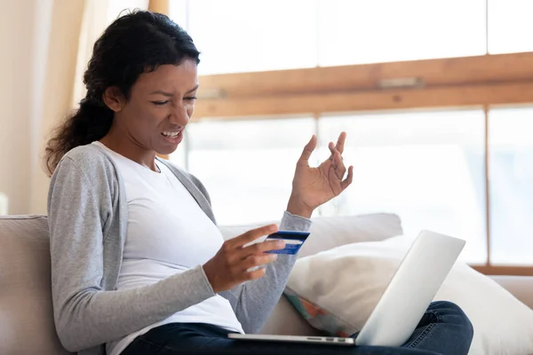 Unhappy young mixed race woman having problems with online shopping. — Stock Photo, Image