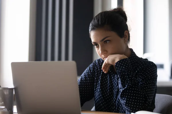Pensive young Indian woman work on laptop — Stock Photo, Image