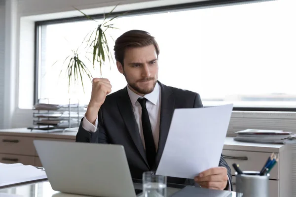 Pensive Caucasian businessman unhappy with paper letter news — Foto de Stock