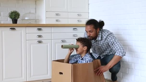 African active father play in kitchen with little son — Stock Video