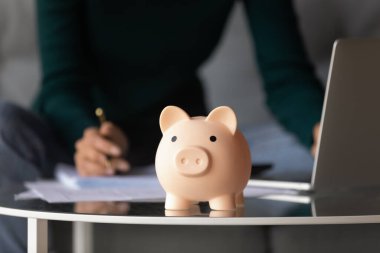 Close up of piggy bank on table clipart