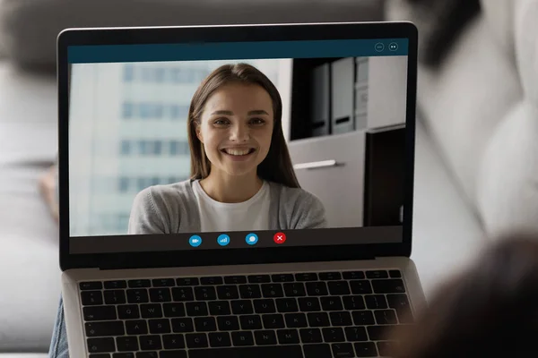 Smiling woman on laptop screen engaged in online call — Stock Photo, Image