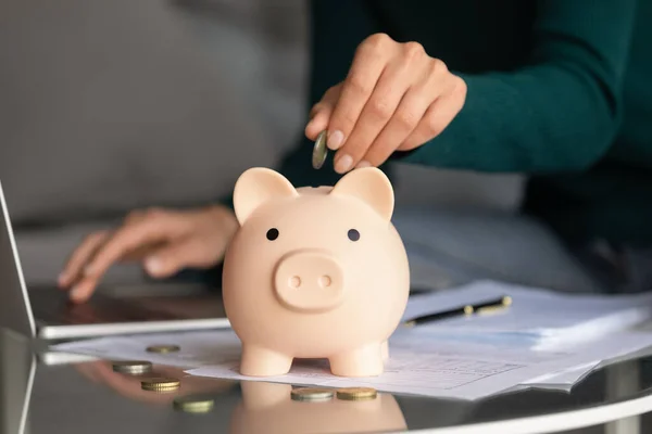 Woman drop coin in piggy bank saving