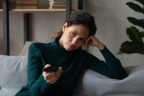 Unhappy woman feel bored watching TV at home — Stock Photo, Image