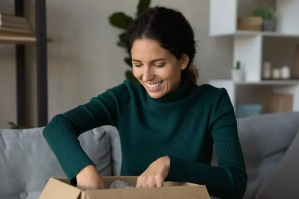 Excited young woman unbox package shopping online — Stock Photo, Image