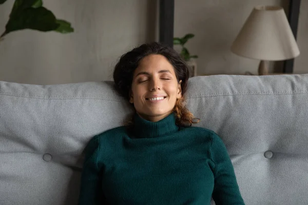 Happy woman rest on couch relieving negative emotions — Stock Photo, Image