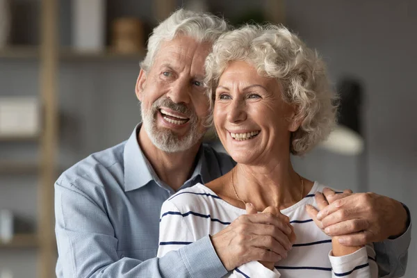 Smiling old middle aged bonding family couple looking in distance. — Stock Photo, Image