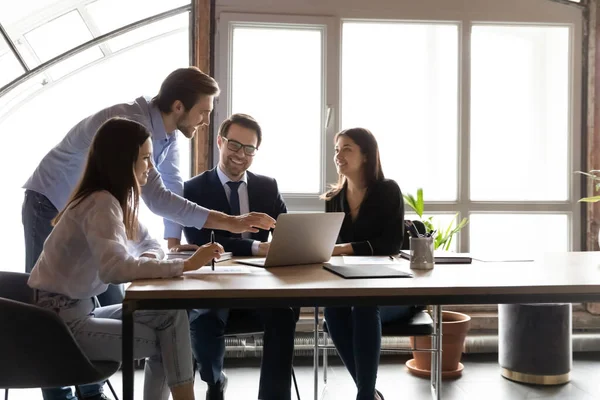 Happy diverse colleagues working on project together, using laptop — Stock Photo, Image