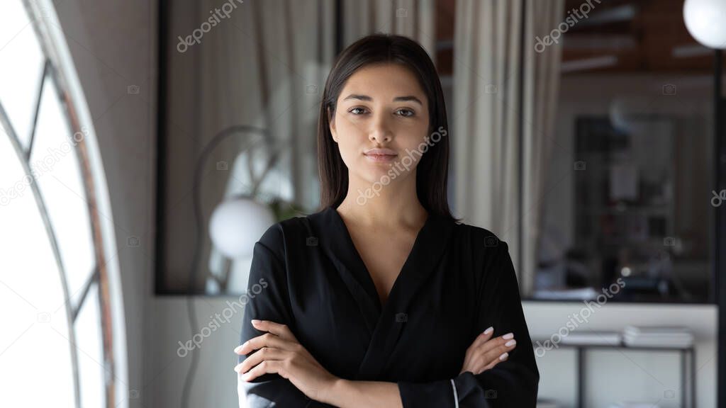 Head shot portrait confident Indian businesswoman with arms crossed