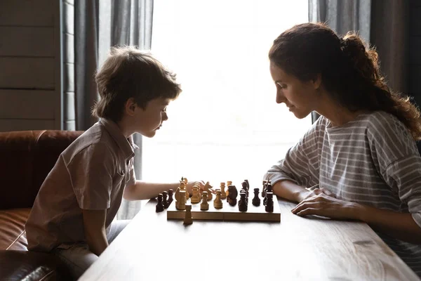 Mãe jogar xadrez com o filho pequeno inteligente — Fotografia de Stock