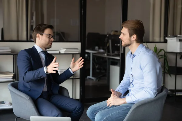 Confident businessmen discussing project, partners negotiations in office — Stock Photo, Image