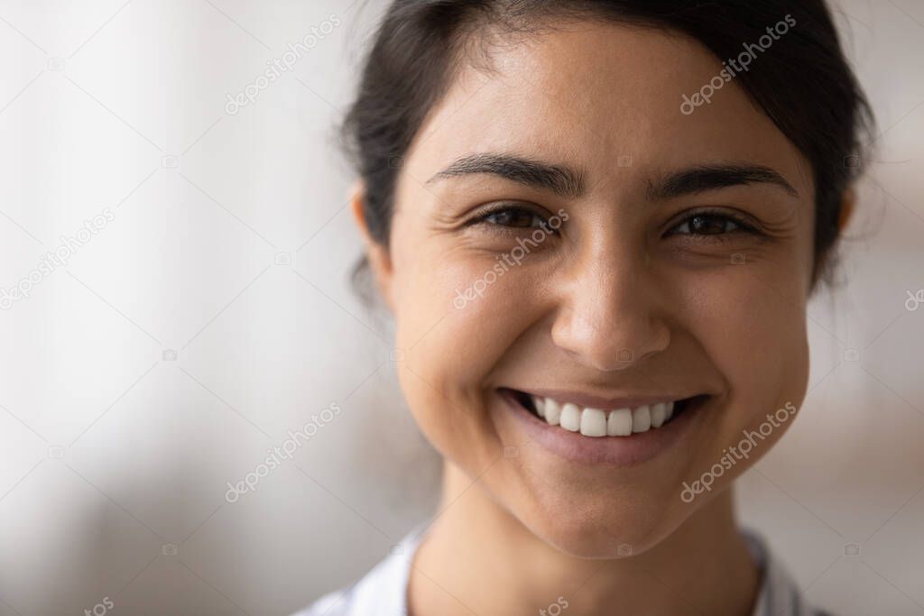 Beautiful indian lady look at camera demonstrate snow white smile