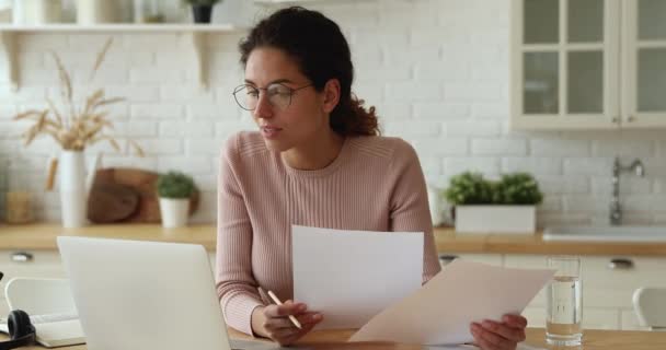 Feliz joven mujer de negocios de 30 años en gafas haciendo papeleo en casa. — Vídeos de Stock