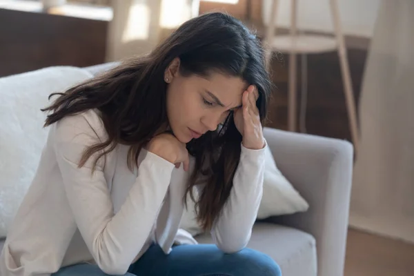 Unhappy young woman touching forehead, thinking about relationship problems — Stock Photo, Image