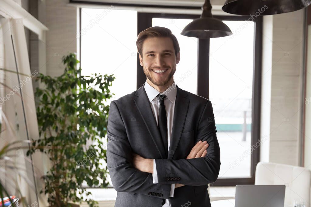 Head shot portrait successful businessman with arms crossed in office