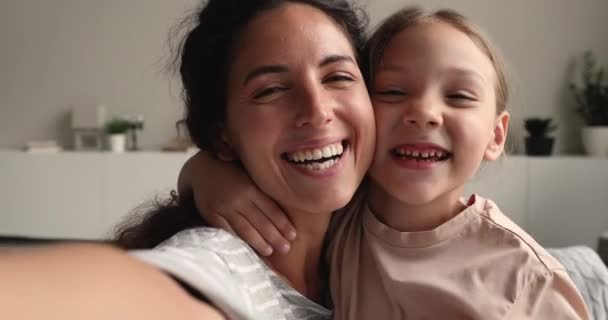 Mom and daughter holding device looking at camera, webcam view — Stock Video