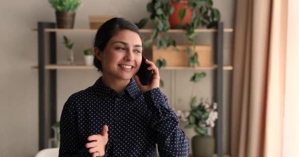 Happy young indian ethnicity business lady holding cellphone call talk. — Stock Video