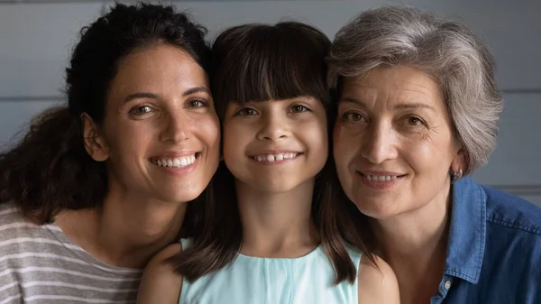 Head shot portrait smiling little girl with grandmother and mother — Stock Photo, Image