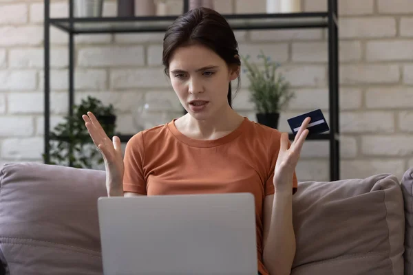 Irritated woman using online banking service, problem with credit card — Stock Photo, Image