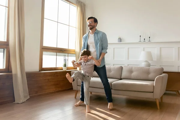 Overjoyed father and son dancing at home — Stock Photo, Image