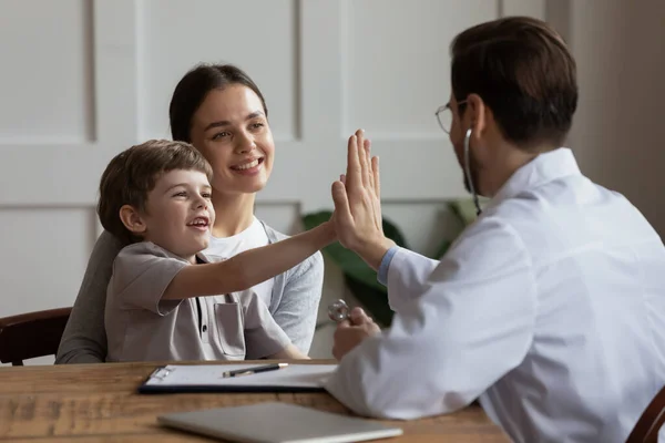 Happy little boy patient give high five to doctor — Stock Photo, Image