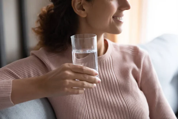 Close up dreamy young woman holding glass of pure water. — Stock Photo, Image
