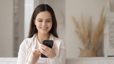 Gülümseyen milenyum kadını internette cep telefonu mesajı kullanıyor