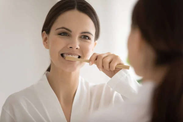 Young woman use eco toothbrush cleaning teeth