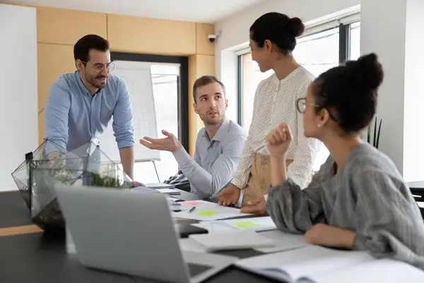 Diverse business team discussing project at corporate briefing — Stock Photo, Image