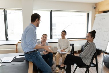 Çeşitli iş grupları toplantı odasında proje stratejisini tartışıyor