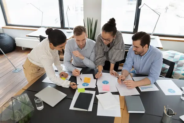 Diverse team of professionals analyzing marketing research — Stock Photo, Image