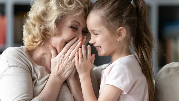 Happy middle aged grandmother having fun with little 7s granddaughter. — Stok fotoğraf