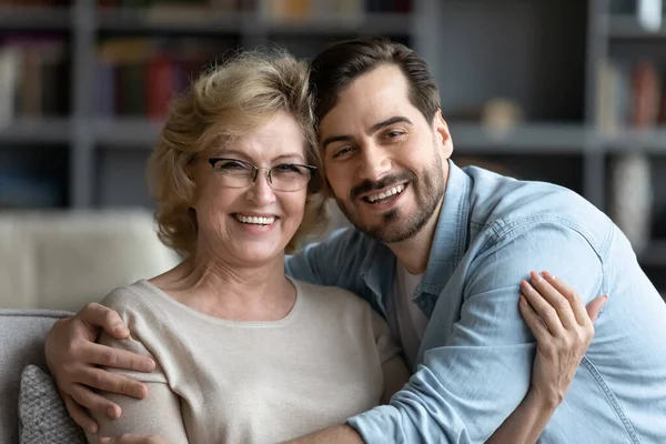 Portrait of smiling young man embracing senior mother in glasses. —  Fotos de Stock