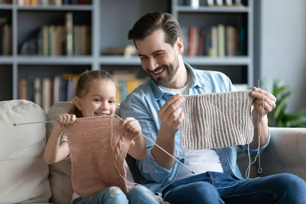 Glad liten 7s unge flicka skapa varma kläder med far. — Stockfoto