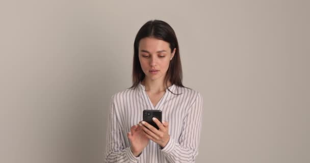 Happy millennial pleased woman using mobile phone applications. — Stock Video