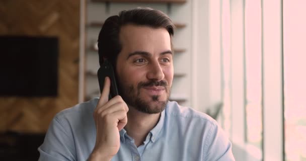 Happy young handsome caucasian man talking on cellphone. — Stock Video