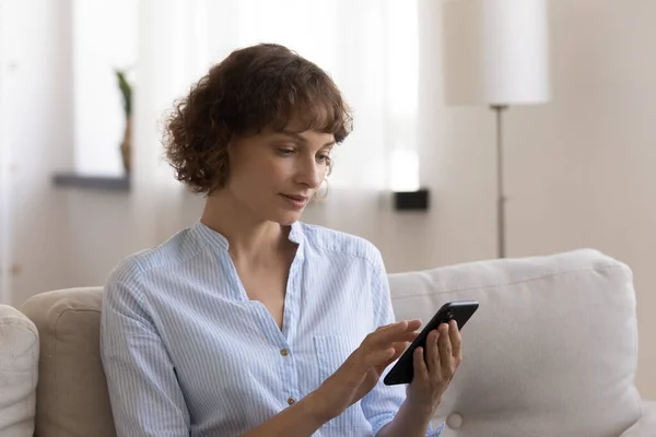 Woman relax at home using smartphone gadget — Stock Photo, Image