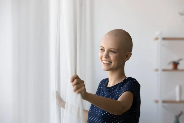 Happy bald cancer patient open curtains feeling good — Stock Photo, Image