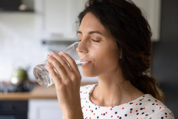 Mujer joven sedienta beber agua de vidrio — Foto de Stock