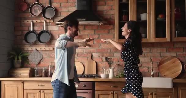 Engraçado jovem casal apaixonado dançando brincando na cozinha — Vídeo de Stock