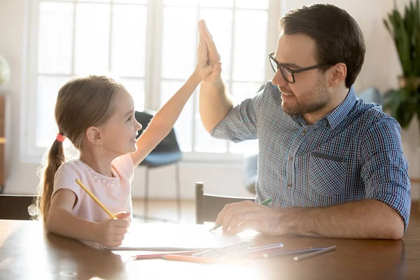 Happy young dad and small daughter give high five — Stock Photo, Image