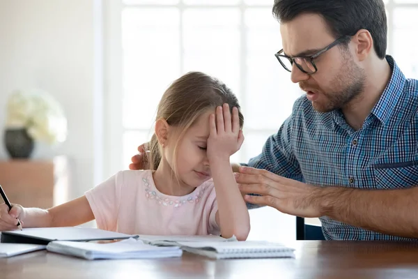 Caring young dad support upset little daughter studying — Stock Photo, Image