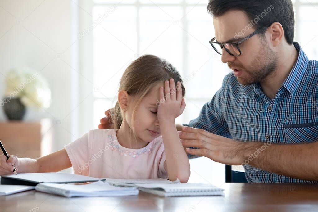 Caring young dad support upset little daughter studying